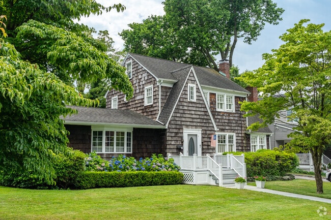Split level home, featuring wood shingles giving a rustic look.