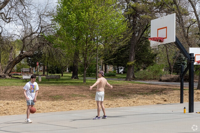 Friends play a one-on-one basketball game at Wilson Park.