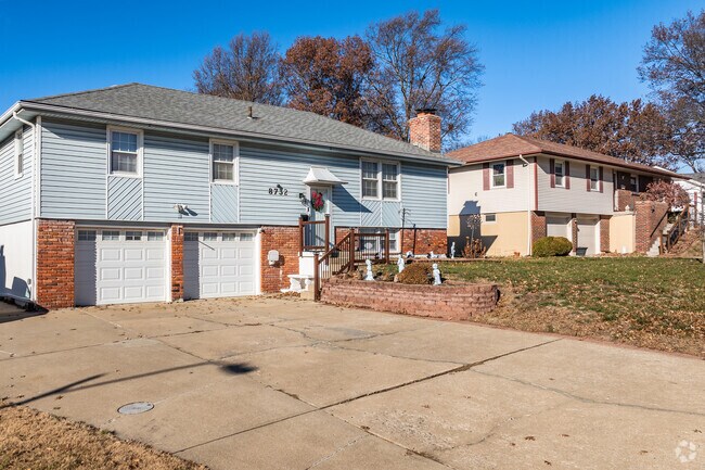 Split-level homes with two-car garages line the streets of the White Oak neighborhood.