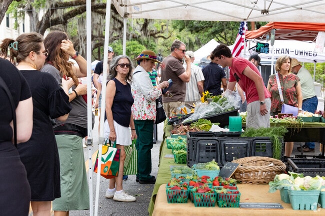 Locals in Savannah shop at the Forsyth Farmers Market for fresh produce.