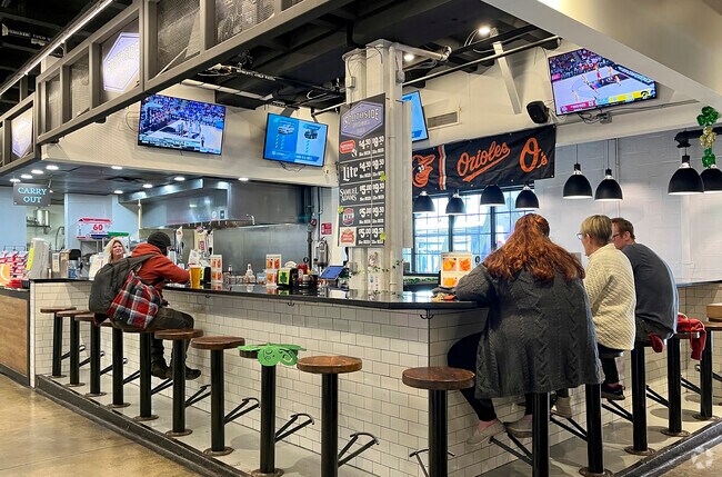 Watch a local sports game at the Cross Street Market near the Sharp Leadenhall neighborhood.