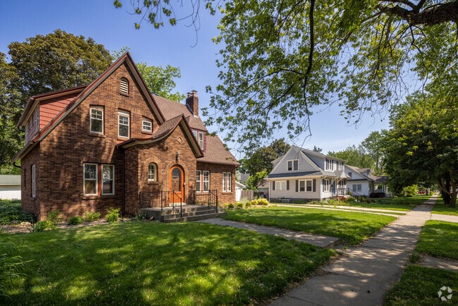 A stately Tudor stands out along a classic Elkhorn block lined with well-kept homes.