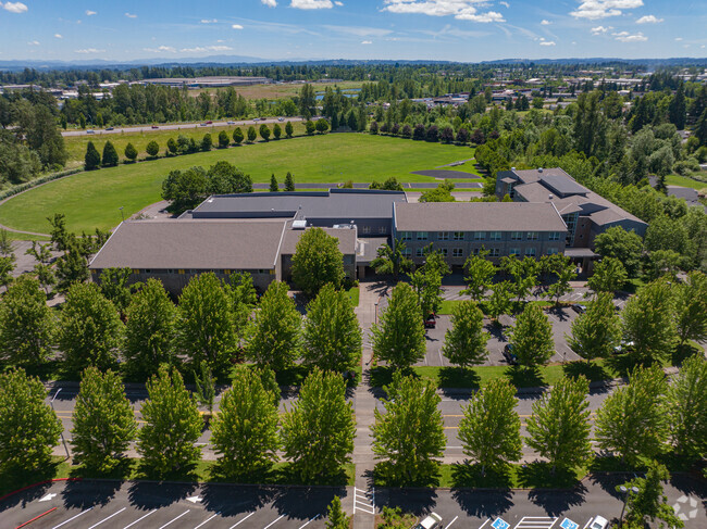 Overview of the tree-lined Claggett Creek Middle School nestled in Keizer, OR.