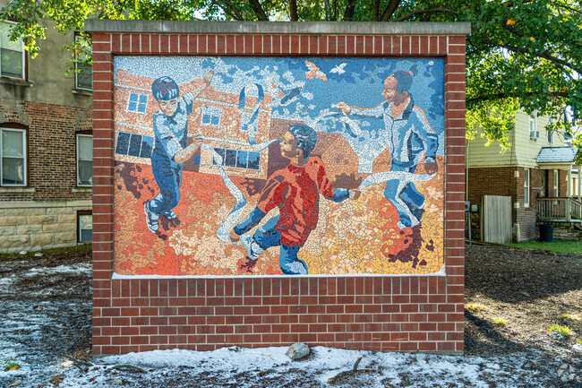 A mural of children playing decorates the neighborhood in Joliet's Cathedral Area.
