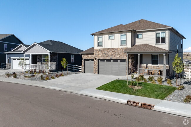 A two story home stands next to a single story home in Crystal Valley Ranch.