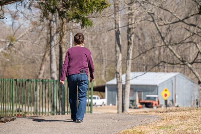 Locals in Odneville enjoy a daily walk at the park.