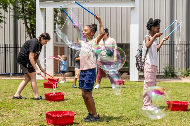 Children love cooling off by playing with oversized bubbles at the Conroe Kidzfest.