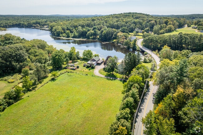 Discover charming views of homes by the pond in Griswold, CT.
