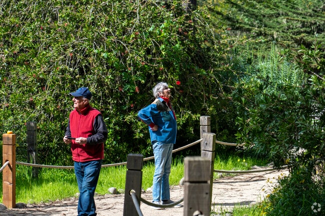 A couple searching for butterflies in the Pacific Grove neighborhood.