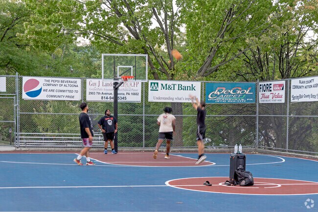 Logantown residents enjoying a game of basketball with friends at Donald E Witherspoon Courts.