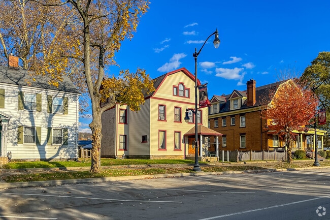 Tree-lined streets in New Brighton showcase rows of traditional single-family homes.