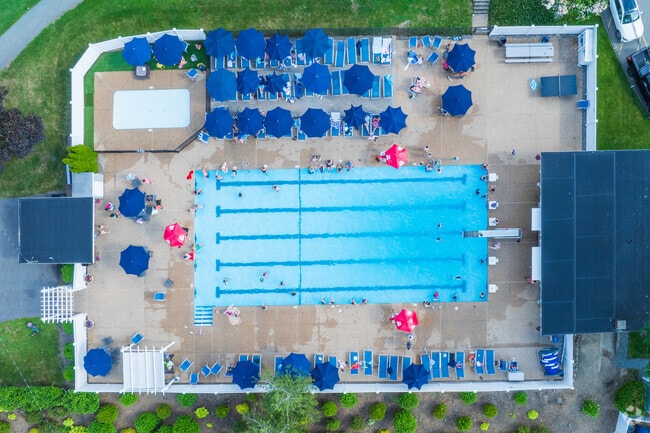 Members of Bear Hill Golf Course enjoy swimming and relaxing at the club pool on a hot summer day.