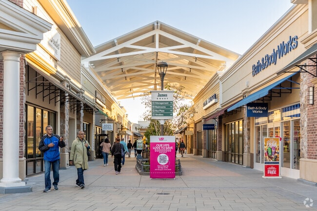 Walking between stores in the setting sun in Norfolk Premium Outlets.