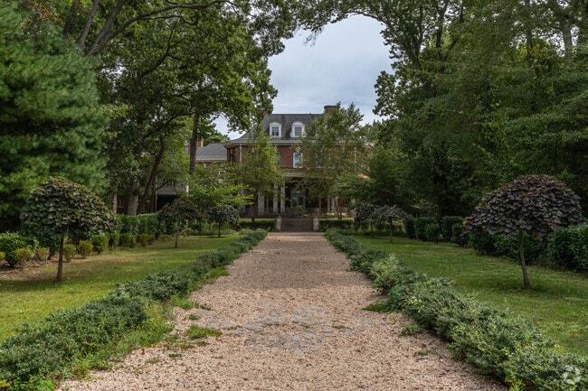 A scenic path leads to the historic Brookwood Hall manor near Islip Terrace.