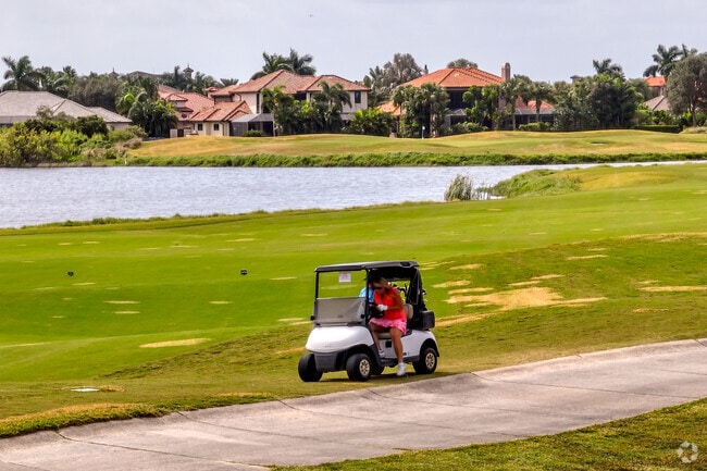 A couple at the Duran Golf Club move along in their golf cart.