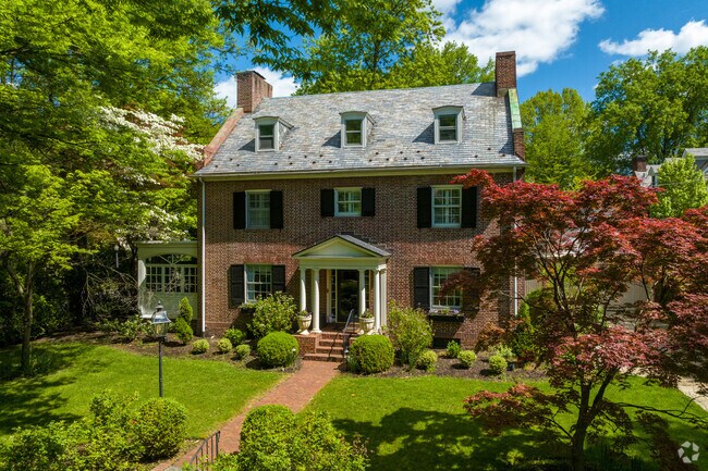 A brick Georgian home shrouded in trees in Wawaset.