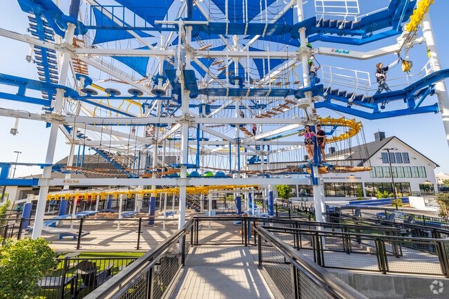 The Sky Time Ropes Course at Pecan Lake Entertainment challenges adventurers with a multi-level climbing experience, perfect for thrill-seekers from Charleston Estates.