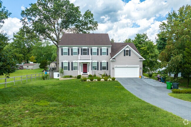 Two-story traditional-style homes in West Elkridge have large, beautiful front yards.