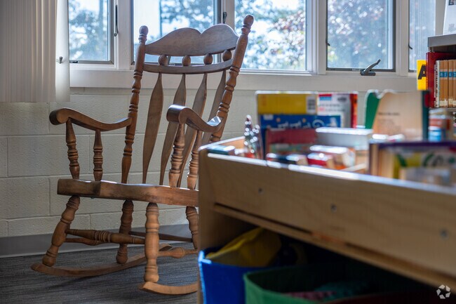 Read a children's book to the little ones in the rocking chair at the Newfield Public Library.