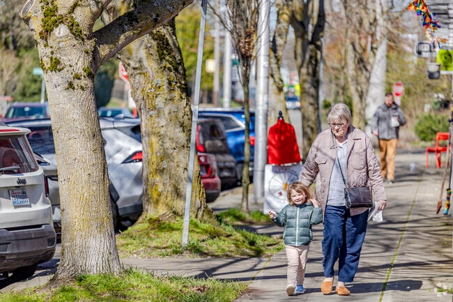 Grandmother and grandchild walk the street of Delridge Way after visiting Fresh Flours.