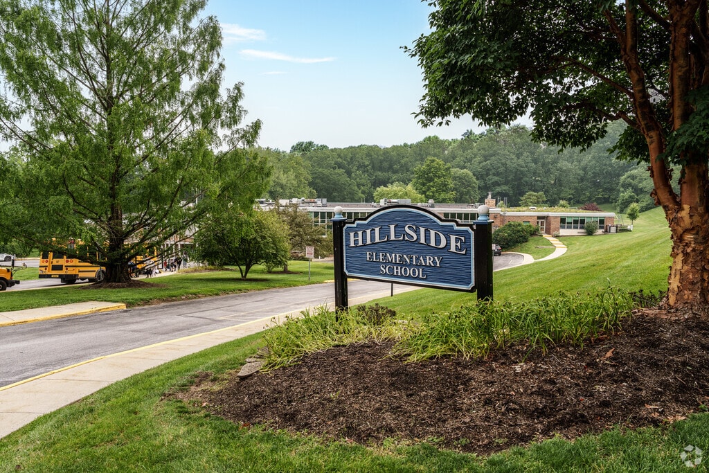 Hillside Elementary School is almost hidden among mature, leafy trees.