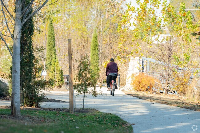 A cyclist riding along the Butterfly Branch Greenway in Northside.
