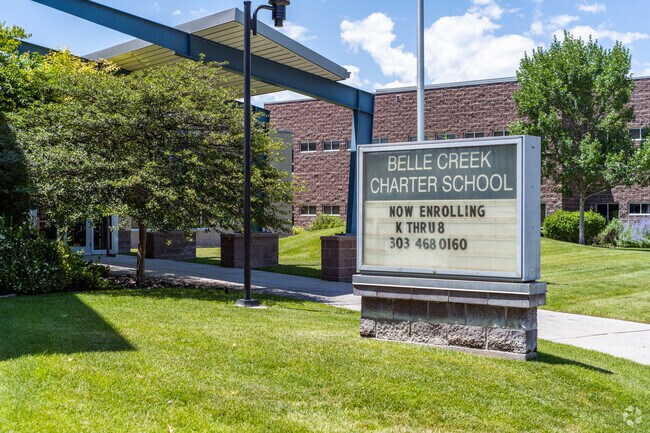 The north entrance and school sign at Belle Creek Charter School in Henderson, Colorado.