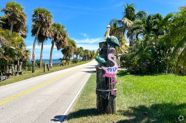 Homeowners decorate their mailboxes and waterfront property with tropical themes in White City.