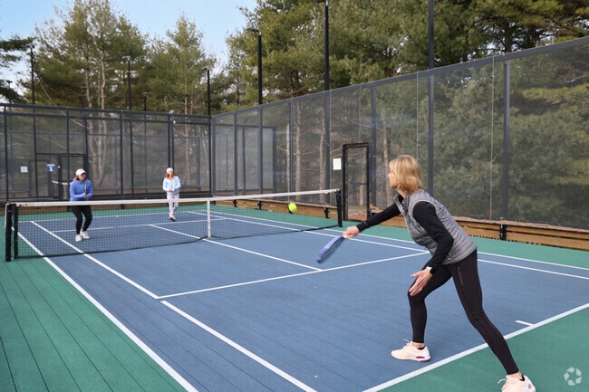 Friends in Essex gather for a paddle ball game at SkyJax Park.