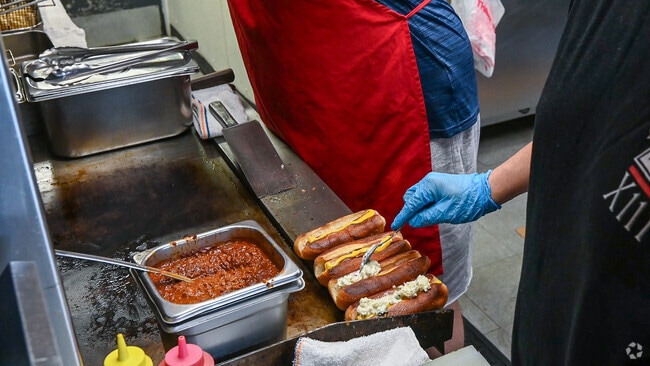 Residents can grab a loaded hotdog from P.B.'s Takeout in the Ardmore neighborhood.