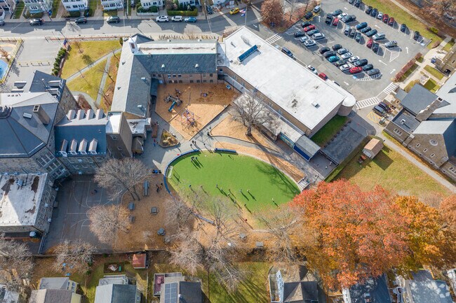 Behind the International School of Boston in West Somerville is a play area with a turf field.