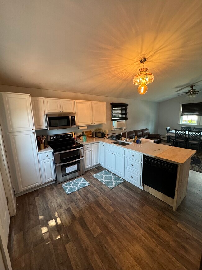 Kitchen with granite countertops and butcher block counter.