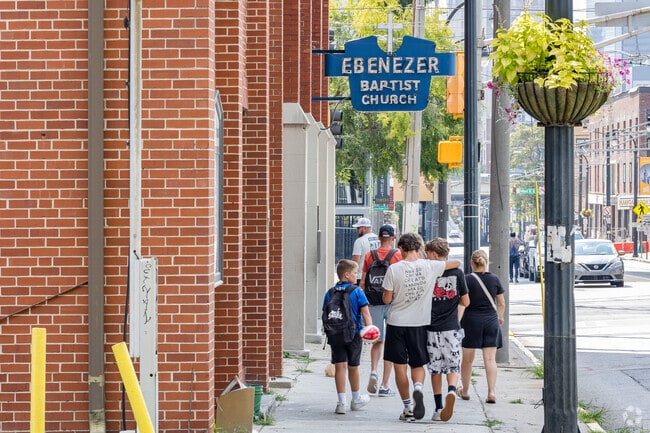 A family walks around the historic spots from MLK Jr.'s past, like his Ebenezer Church.