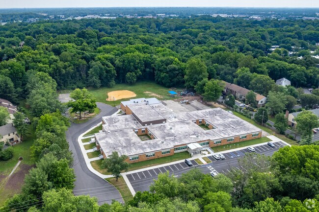 Surrounded by the privacy of green trees in Cherry Hill.