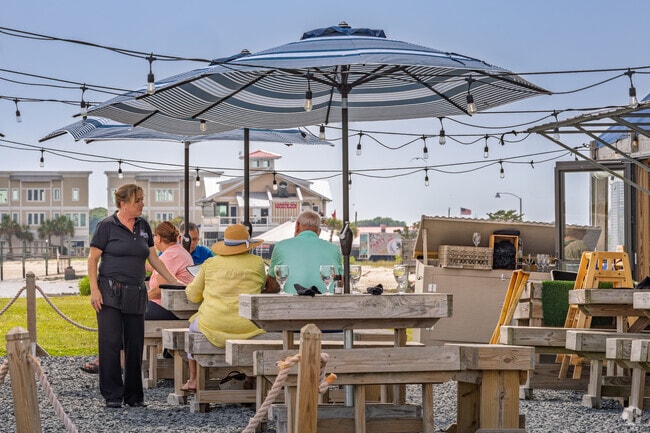 Locals from Boiling Spring Lakes enjoy waterfront dining under umbrellas at Oliver's
