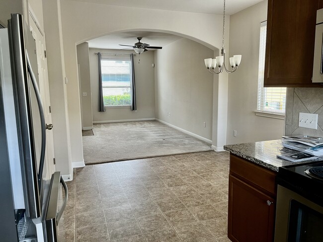 From kitchen looking through dining room into living room