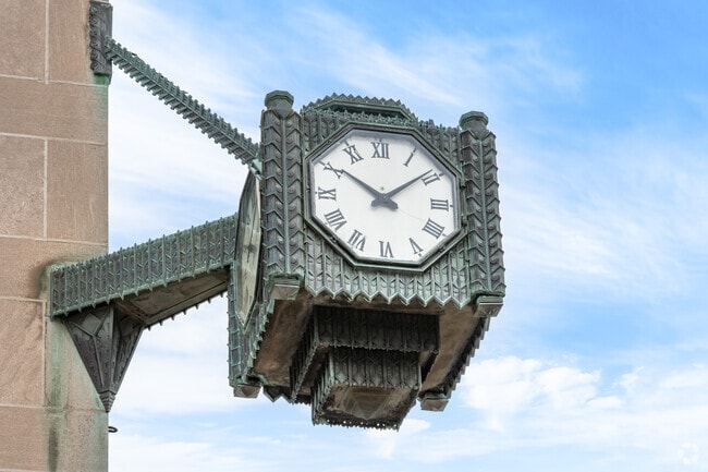 Downtown Evanston’s iconic clock tower stands tall against a clear blue sky, blending timeless design with neighborhood charm.