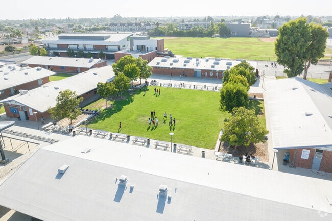 Aerial view of Warner Middle School courtyard shows children playing.