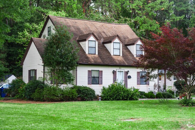 Quaint cap cods nestled in lush greenery in Jenkins.