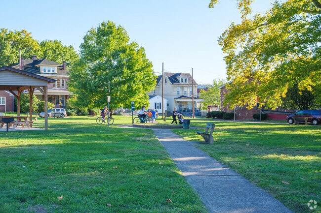 Neighbors smile and say hello as they cross paths at Edgewood Park in Woodsdale.