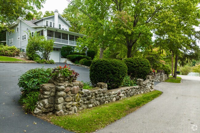 A stone wall marks the start of the driveway of a home in Tower Lake Park.