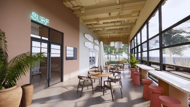 Surf Shack lounge with open-air doors and a variety of seating options facing the shore.