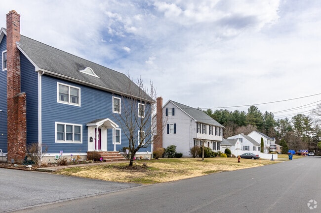 A colorful blue Colonial styled home along with a Garrison styled home in central Tewksbury, MA.