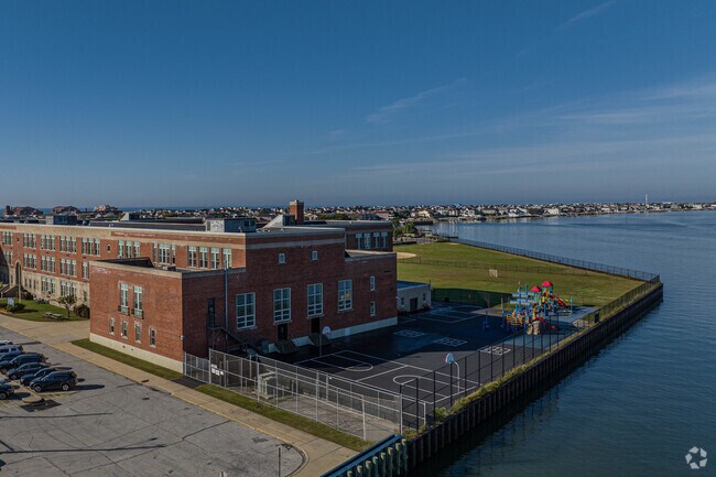 The back of the school with playground sits next to the water way the is known as Broad Channel.