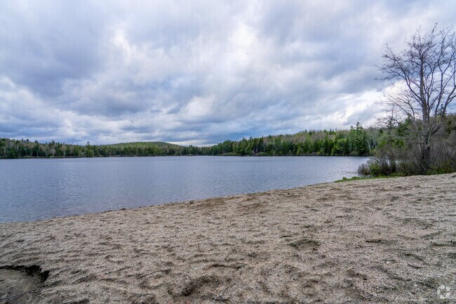 Plainfield Pond, with its quiet sandy beach and clear waters, offers a serene and picturesque retreat.