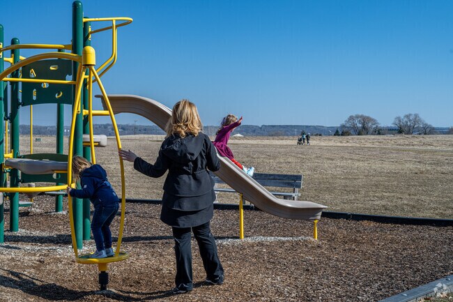Families enjoy the playground at Oak Park Crossing.