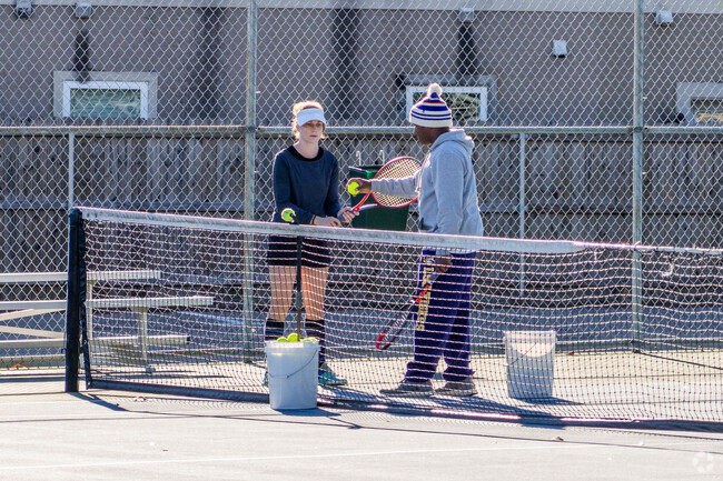 A resident of Bocage takes tennis lessons at Jefferson Highway Park.