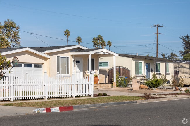 This smaller Craftsman with detached garage and white picket fence in Oxnard has charm.