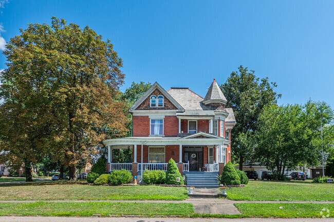 A Victorian home stands out among the other homes as you travel around the neighborhood.
