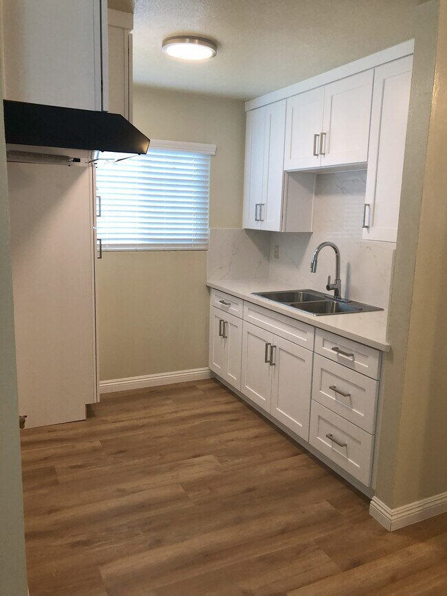 Kitchen cabinetry is new with plenty of room for dishes, pots and pans .